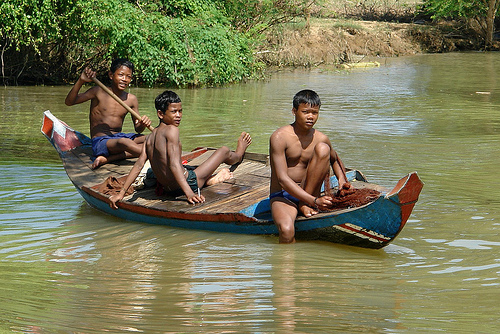 Cambodians and Canoe on Stung Sangker River in NW Cambodia