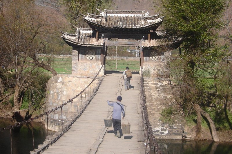 Chinese peasants crossing Footbridge at Shigu