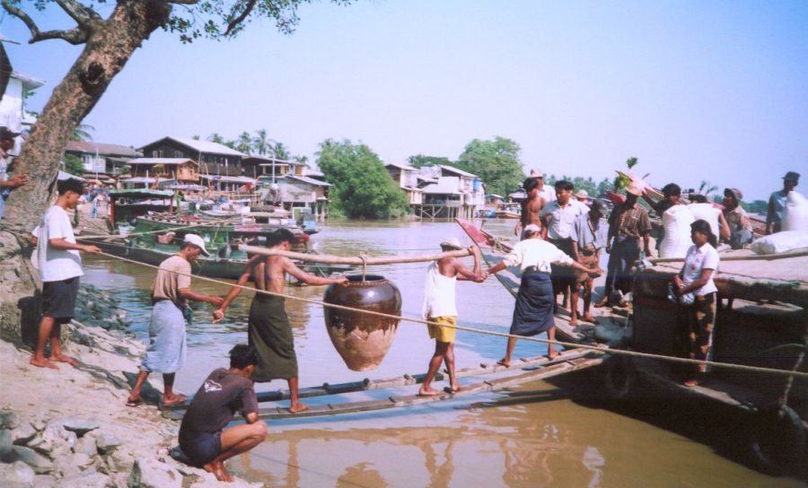 Porters loading boat at at Thanlyin at the confluence of the Yangon and Bago Rivers