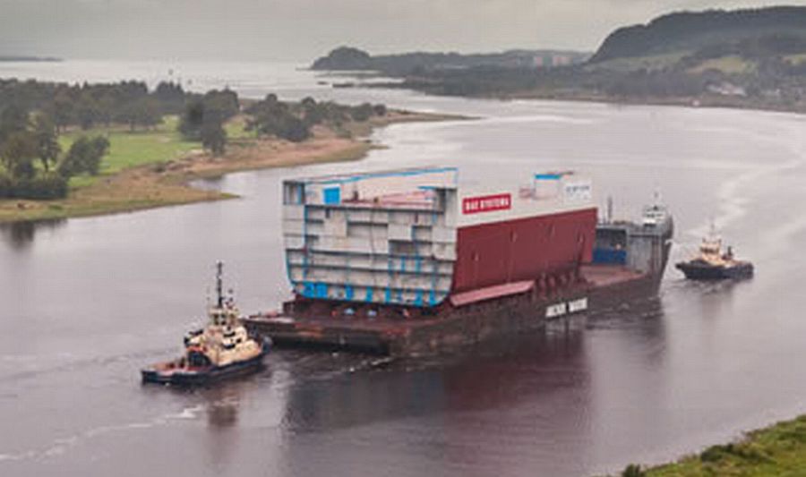 Barge carrying section of aircraft carrier down the River Clyde from the Erskine Bridge
