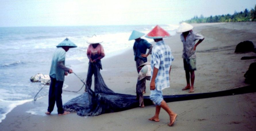 Fishermen on beach near Padang on Sumatra