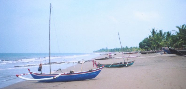 Out-rigger Fishing boats on beach near Padang on Sumatra