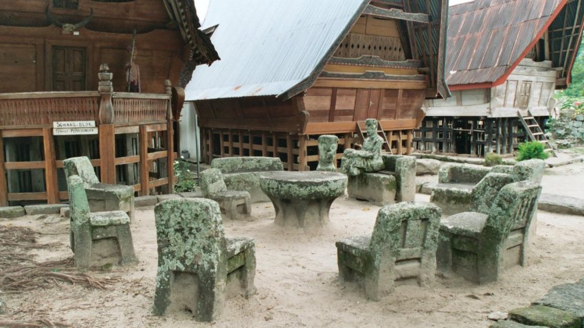 Stone chairs and statue at Ambarita Village on Pulau Samosir in Lake Toba, Sumatra